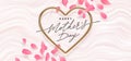 Mothers day vector illustration. Calligraphic greeting in heart shaped metallic frame and flower petals on a pink fluid background